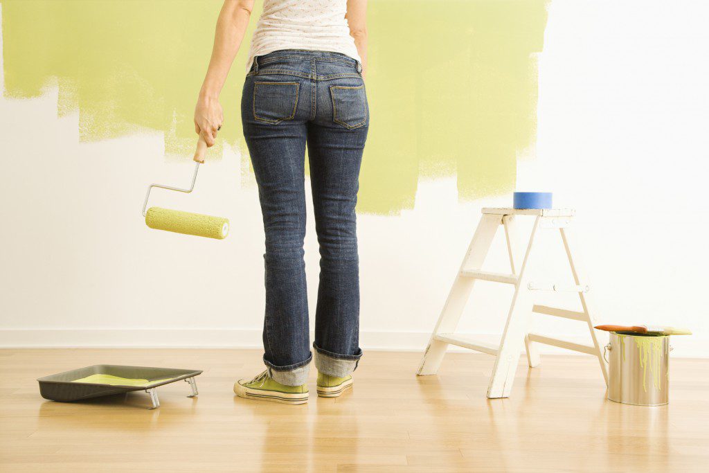 woman painting wall